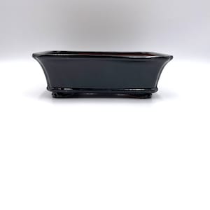 May include: Black rectangular bonsai pot with a glazed finish and three small feet.
