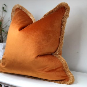 Orange velvet cushion cover. Luxury Pillows with biscuit fringe trim. home decor