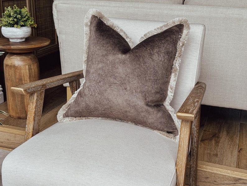 mocha textured velvet look cushion cover with fringe.
