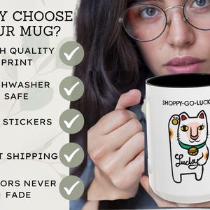 May include: White ceramic mug with a black interior, featuring a cartoon lucky cat design and the text "SHOPPY-GO-LUCKY". The mug also has the text "Lucky" and is dishwasher safe.