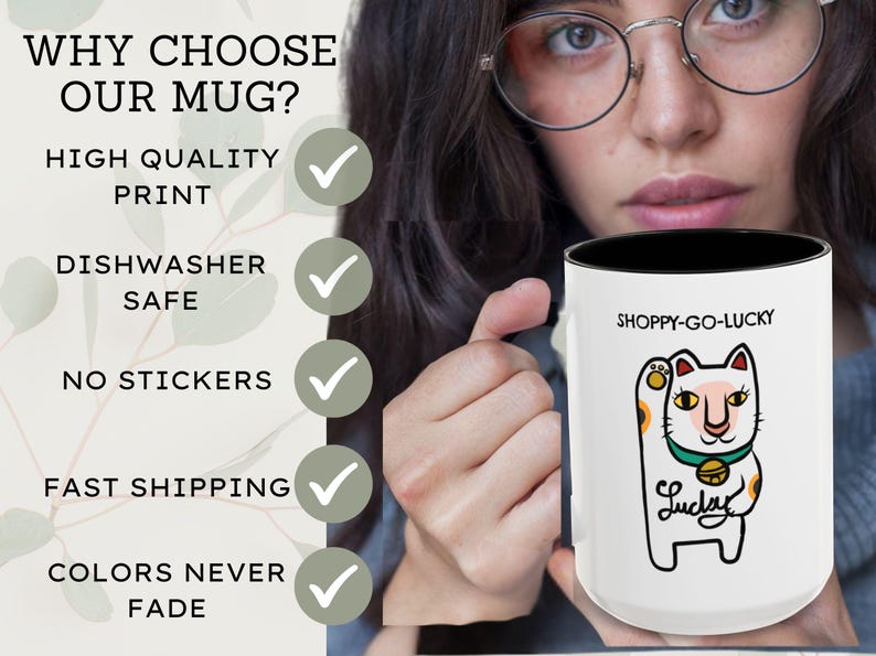 May include: White ceramic mug with a black interior, featuring a cartoon lucky cat design and the text "SHOPPY-GO-LUCKY". The mug also has the text "Lucky" and is dishwasher safe.