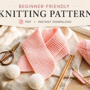 May include: A light pink knitted scarf with white pom-poms at the ends, accompanied by a ball of pink yarn, wooden knitting needles, and metal scissors. The text reads BEGINNER FRIENDLY KNITTING PATTERN PDF INSTANT DOWNLOAD.