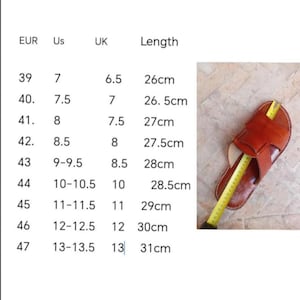 May include: A brown leather sandal with a cross-strap design is measured with a yellow tape measure. The image also includes a size chart with EUR, US, and UK sizes, and lengths in centimeters, ranging from 26cm to 31cm.