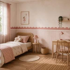 May include: A child's bedroom with a light wood bed, desk, and chair. The walls are painted white with pink stripes and a scalloped border. A pink lamp, a flower pillow, and a framed picture of a girl with a balloon add to the room's decor.