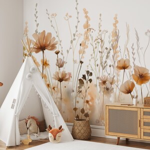 May include: A children's room with a white teepee tent, a giraffe plush toy, and a wooden cabinet. The wall features a floral mural in shades of brown and beige, creating a warm and inviting atmosphere. A woven basket and decorative pillows add to the cozy feel.