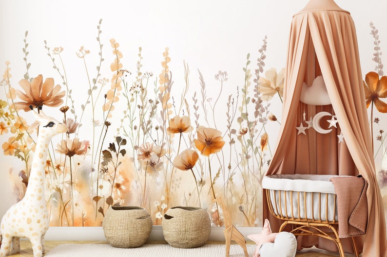 May include: A nursery scene featuring a floral wallpaper with watercolor-style flowers in shades of orange, brown, and beige. A giraffe toy, two woven baskets, and a canopy bed with a decorative mobile complete the room's decor.