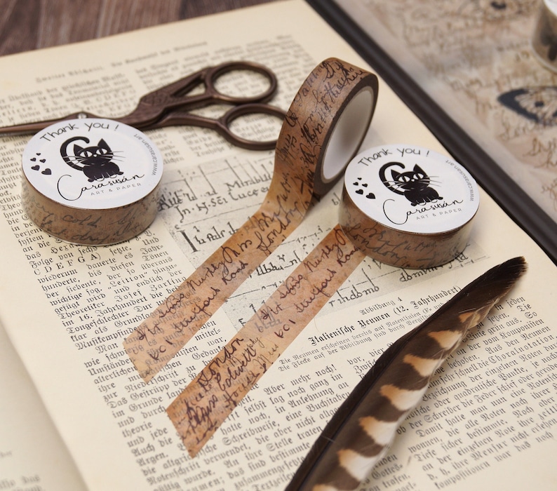 May include: Two rolls of brown patterned washi tape with black cat illustrations and the text "Thank you! Carasusan ART & PAPER".