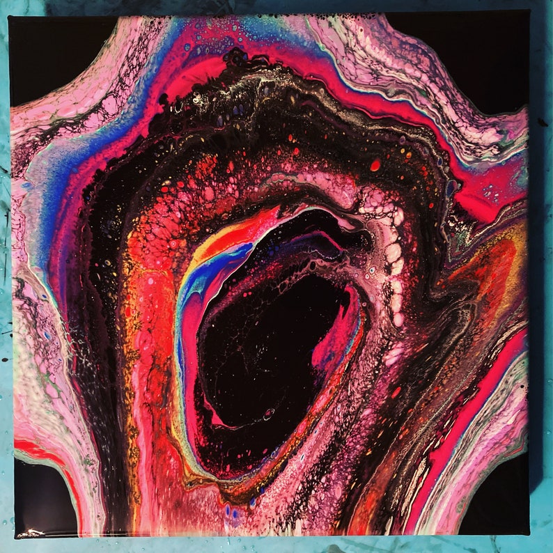 May include: Abstract painting with swirling pink, red, blue, and black colors. The painting features a large, dark, circular shape in the center.