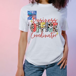 May include: White t-shirt with the text "Business Office Coordinator" in colorful letters with a leopard print design.