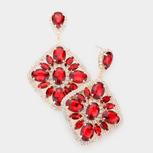 May include: A pair of gold tone dangle earrings with red and clear crystal embellishments. The earrings feature a square shape with a cluster of red crystals in the center and clear crystals around the edges.
