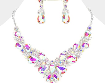 May include: A silver necklace and earrings set with iridescent teardrop-shaped crystals. The necklace features a cascading design with multiple crystals.