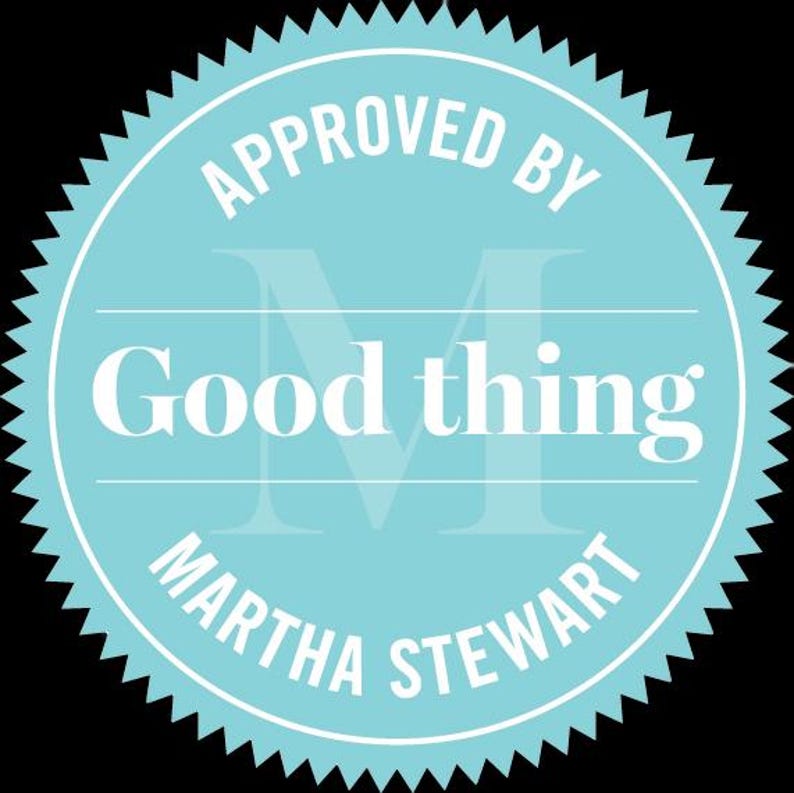 May include: A circular, pale blue seal with a white, serrated edge. The words "APPROVED BY" are at the top, "Good thing" in the centre, and "MARTHA STEWART" at the bottom. A faded "M" design is in the background.