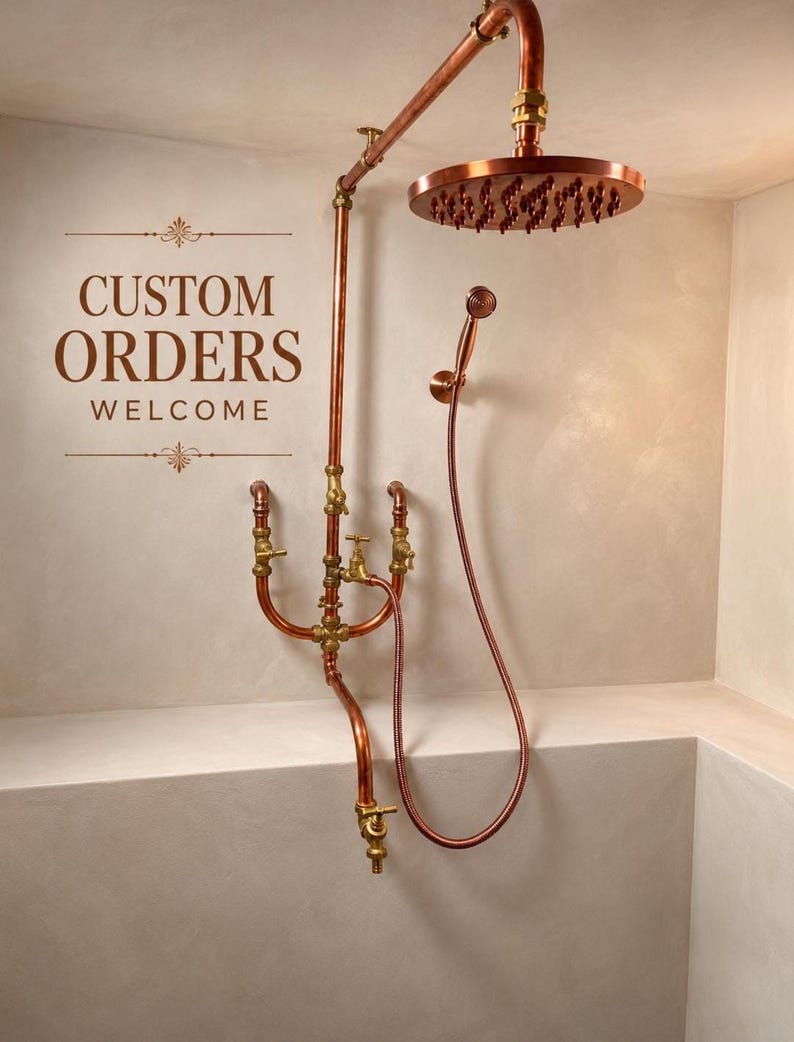 May include: Copper shower fixture with a round showerhead and handheld showerhead. The fixture has a vintage aesthetic with exposed pipes and brass fittings. The text "CUSTOM ORDERS WELCOME" is displayed on the wall.