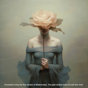 May include: A woman in a blue dress holds a large, pale yellow rose in front of her face. The rose is so large that it covers her entire face. The background is a soft, muted grey.