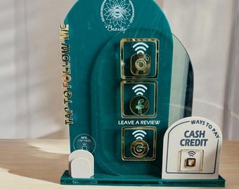 May include: A green acrylic stand with a gold trim and a white bee logo that says "Willow Bee Beauty". The stand has icons for Instagram, Facebook, and Google, and says "Tap to Follow Me" and "Leave a Review". There is a white sign that says "Ways to Pay" and "Cash Credit" with a gold icon of a credit card.