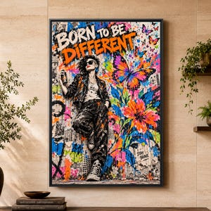 May include: A rectangular wall art print featuring the text BORN TO BE DIFFERENT in bold orange and white letters. The image depicts a person in a dark jacket and pants holding a spray can, surrounded by vibrant butterflies and flowers.