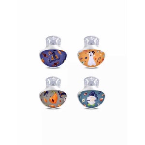May include: Four white Halloween-themed bottle stoppers with different designs. Each stopper features a different Halloween character or symbol, including a ghost, a witch, a pumpkin, and a skull.