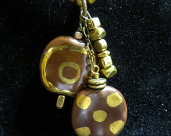 Gold bead necklace with dangling beads of brown and gold