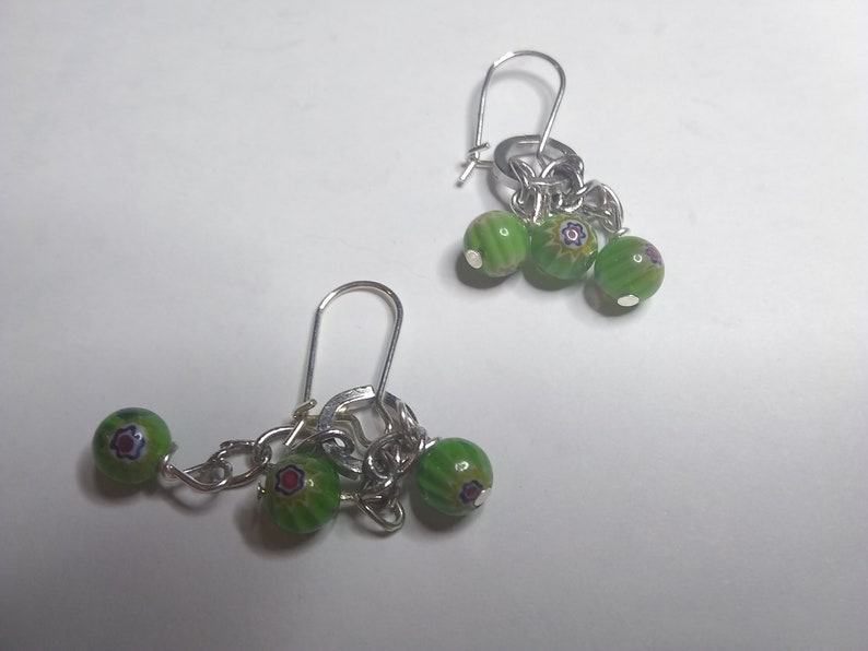 very cute Earrings with dangling round green beads with 3 with red and blue accents