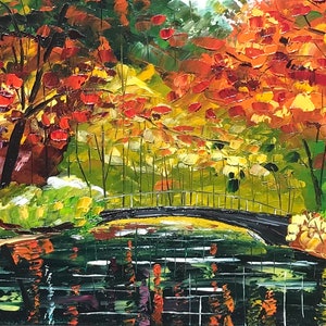 May include: A painting of a bridge over a pond in a forest. The trees are in autumn colors of red, orange, and yellow. The water is dark green and reflects the trees. The painting is signed "T.de Silva".