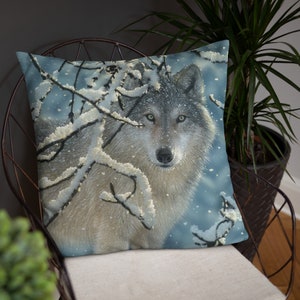 May include: A gray wolf with green eyes stands in a snowy forest. The wolf is looking directly at the viewer. The background is a blue and white snowy scene.