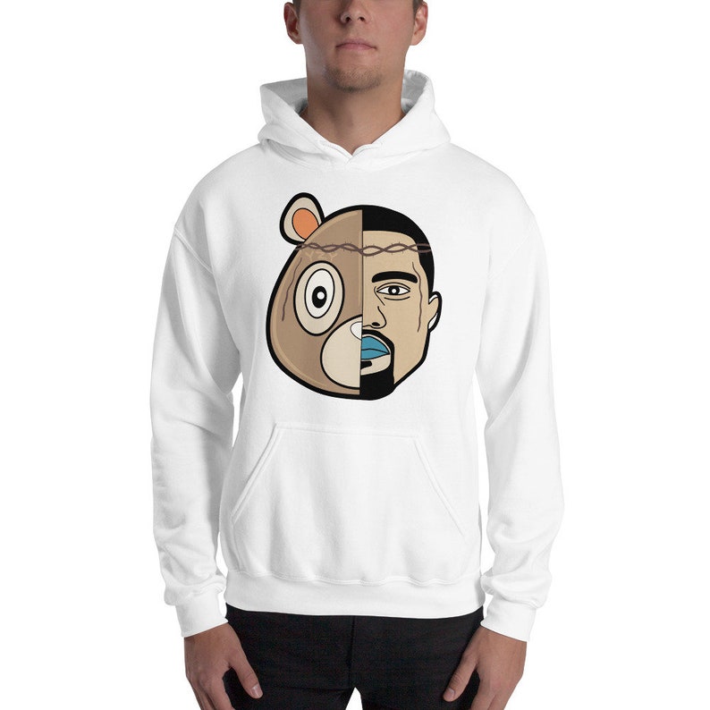 May include: White hooded sweatshirt featuring a graphic print of a cartoon bear and a man's face. The bear's face is on the left side of the graphic and the man's face is on the right side. The bear has a brown nose, brown fur, and a black eye. The man has a brown beard, brown hair, and blue lips.