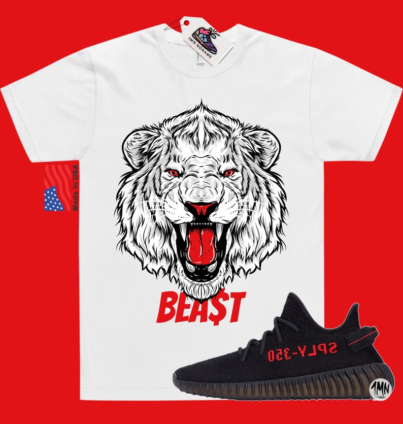 May include: White t-shirt with a black and white lion graphic and the word "BEAST" in red. A black and red Adidas Yeezy Boost 350 V2 sneaker is shown below the shirt.