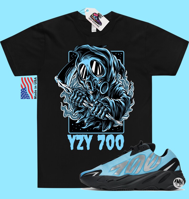 May include: Black t-shirt with a graphic of a blue hooded figure wearing a gas mask and holding a scythe. The text "YZY 700" is printed below the graphic. A pair of blue and black Yeezy 700 sneakers are also pictured.