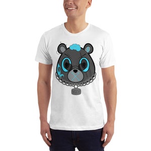May include: White t-shirt featuring a black and blue cartoon bear head wearing a chain with a tag that says "VZY".