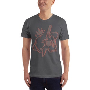 May include: A dark gray t-shirt with a red outline of a skull with a knife through it. The skull has a crown on top and the word "king" tattooed on it. The skull is surrounded by barbed wire.
