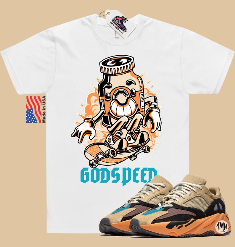 May include: White t-shirt with a cartoon illustration of a pill bottle skateboarding with the text "Godspeed". A pair of tan, black, and orange sneakers with a blue accent are shown below the t-shirt.