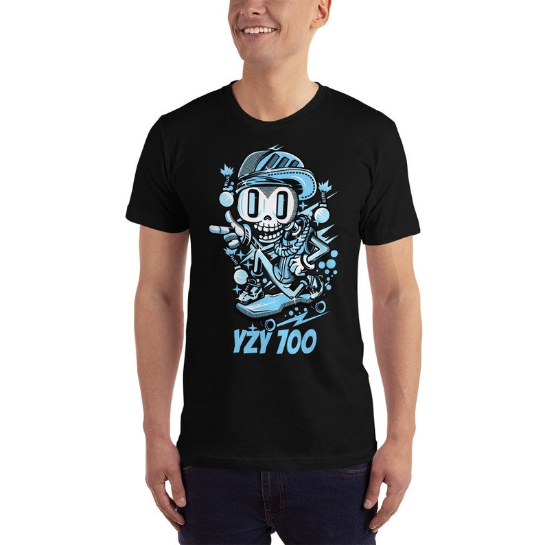 May include: Black t-shirt with a cartoon illustration of a blue skeleton wearing a blue hat and sunglasses, skateboarding. The text "YZY 700" is printed below the illustration.