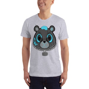 May include: A grey t-shirt featuring a black and blue cartoon bear wearing a chain with a tag that says "YZY".