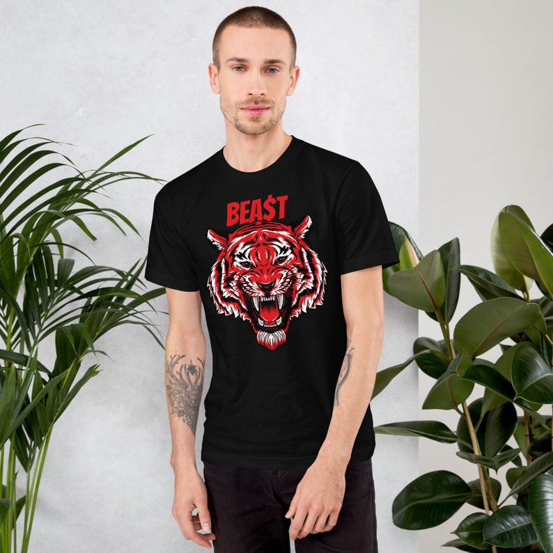 May include: Black t-shirt with a red tiger graphic and the word "BEAST" in red letters.