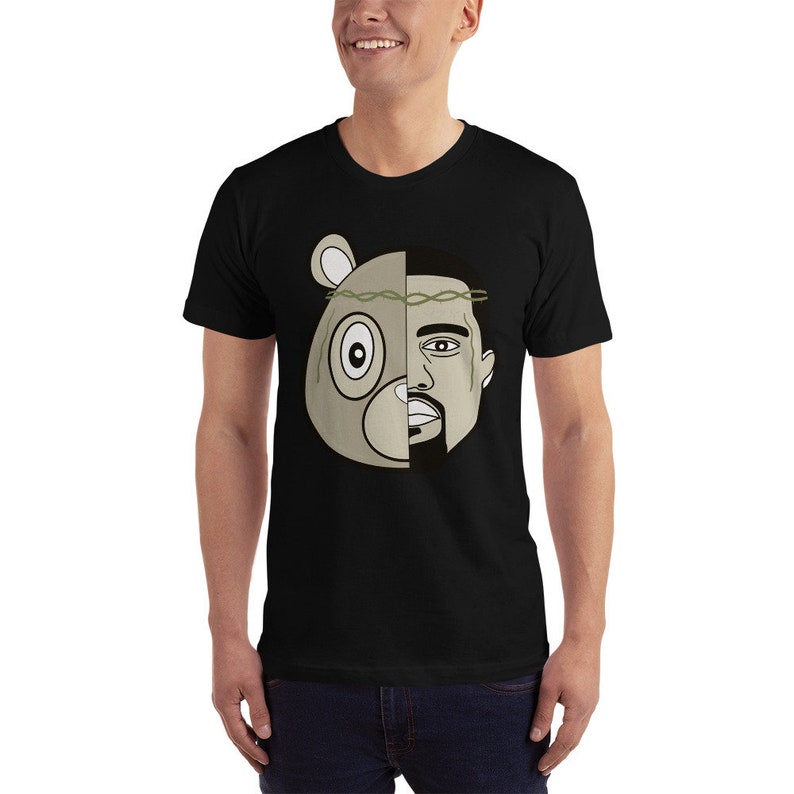 May include: Black t-shirt with a graphic of a bear head with a crown of thorns and a man's face on the right side of the head.
