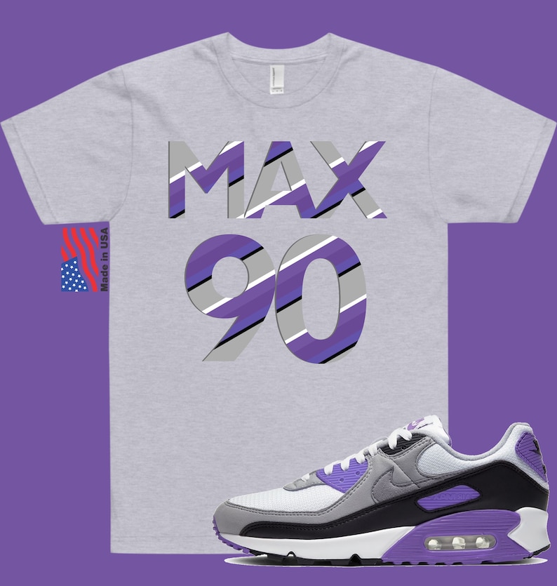 May include: A grey t-shirt with the text "MAX 90" in purple, white, and grey stripes. The shirt is paired with white, grey, and purple Nike Air Max 90 sneakers.