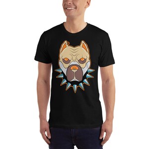 May include: A black t-shirt with a graphic of a white pit bull dog wearing a spiked collar. The dog's eyes are orange and the collar is blue and orange.