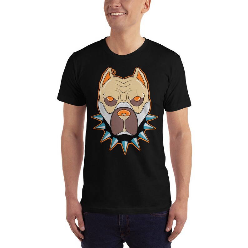May include: A black t-shirt with a graphic of a white pit bull dog wearing a spiked collar. The dog's eyes are orange and the collar is blue and orange.