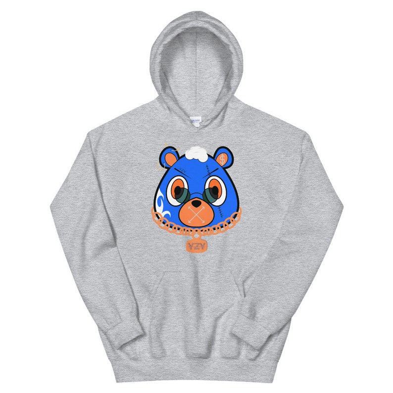 May include: A gray hoodie with a blue bear face graphic. The bear has a chain with a pendant that says "YZY".