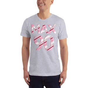 May include: A gray t-shirt with a pink and red striped design that says "MAX 90" on the front.