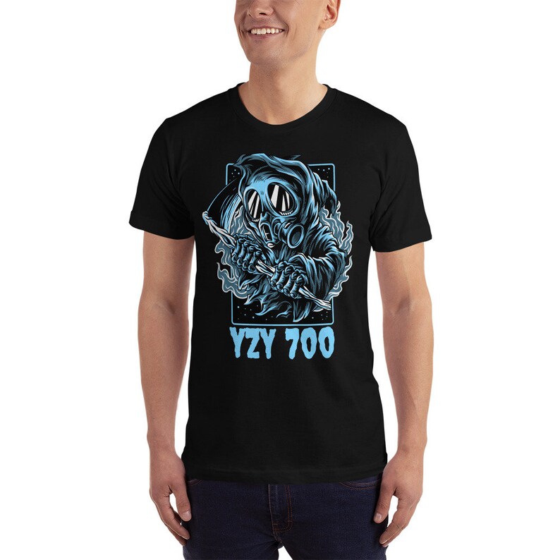 May include: Black t-shirt with a blue graphic of a hooded figure wearing a gas mask and holding a scythe. The text "YZY 700" is printed in blue below the graphic.