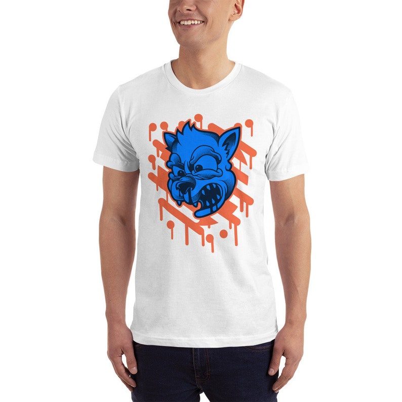 May include: White t-shirt with a blue cartoon wolf head graphic. The wolf has an angry expression and is surrounded by orange dripping paint.