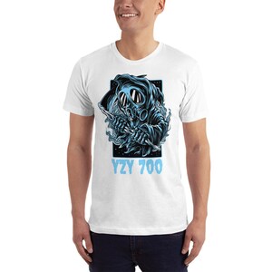 May include: White t-shirt with a blue graphic of a hooded figure wearing a gas mask and holding a scythe. The text "YZY 700" is printed below the graphic.