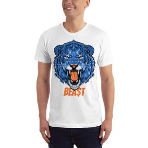 May include: White t-shirt with a blue lion graphic and the word "BEAST" in orange letters.