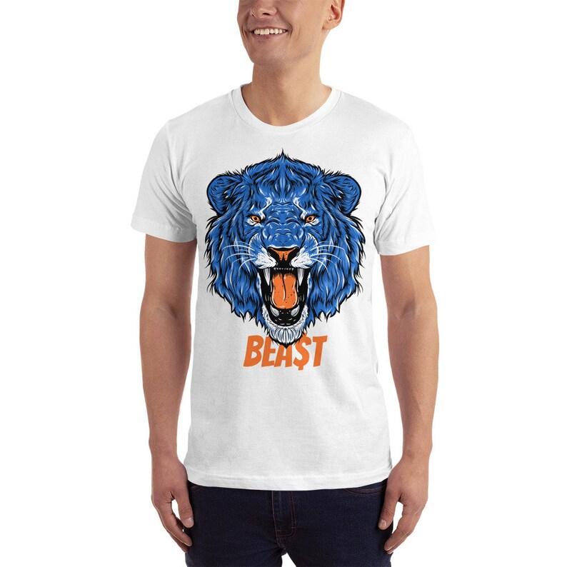 May include: White t-shirt with a blue lion graphic and the word "BEAST" in orange letters.