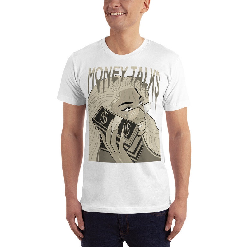 May include: White t-shirt with a graphic print of a woman holding a stack of money to her ear. The text "MONEY TALKS" is printed in dripping letters above the woman's head.