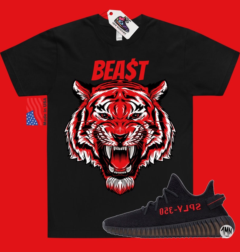 May include: Black t-shirt with a red tiger graphic and the word "BEAST" in red. A pair of black and red Yeezy sneakers are shown below the t-shirt.