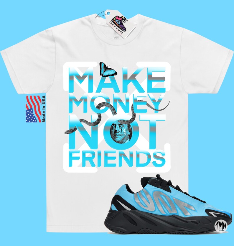 May include: White t-shirt with a blue and grey graphic that says "Make Money Not Friends". A blue and black sneaker with a silver accent is in the bottom right corner of the image.