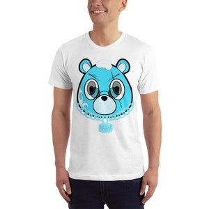 May include: White t-shirt with a blue cartoon bear wearing a chain with a tag that says "YZY" on it.