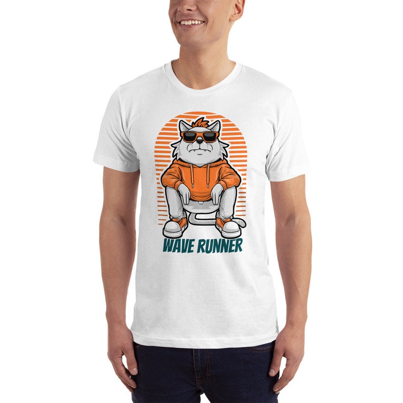 May include: White t-shirt with a cartoon cat wearing sunglasses and an orange hoodie, sitting on a white chair. The cat has a red headband and the text "WAVE RUNNER" is printed below the cat.